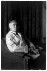 Maurice Maeterlinck, three-quarter-length portrait, seated facing right, with open book in hands LCCN91481030