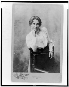Maud Ballington Booth, half-length portrait, standing behind chair, facing front LCCN99401131
