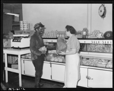 Max Schultz, miner, buying groceries from Mrs. Paul Stevenson, clerk at company store. Pittsburgh Coal Company... - NARA - 540249