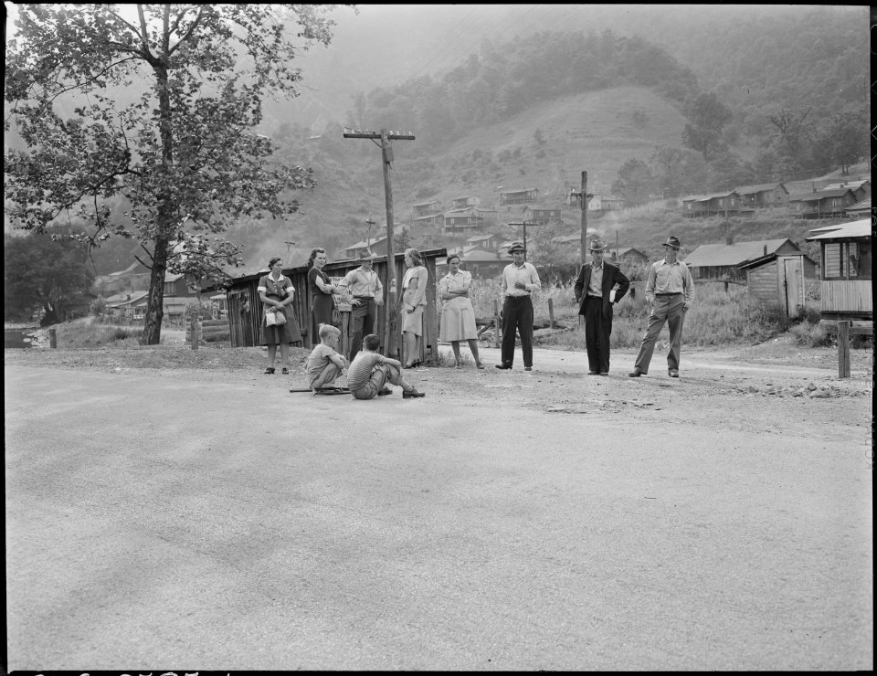 Mr. and Mrs. Blaine Sergent wait for the bus which will take them to Harlan for Saturday afternoon shopping. There is... - NARA - 541321