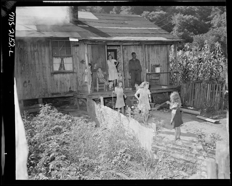 Mr. and Mrs. Ceph Holland and their six children in front of their three room house about which they said, They (the... - NARA - 541141