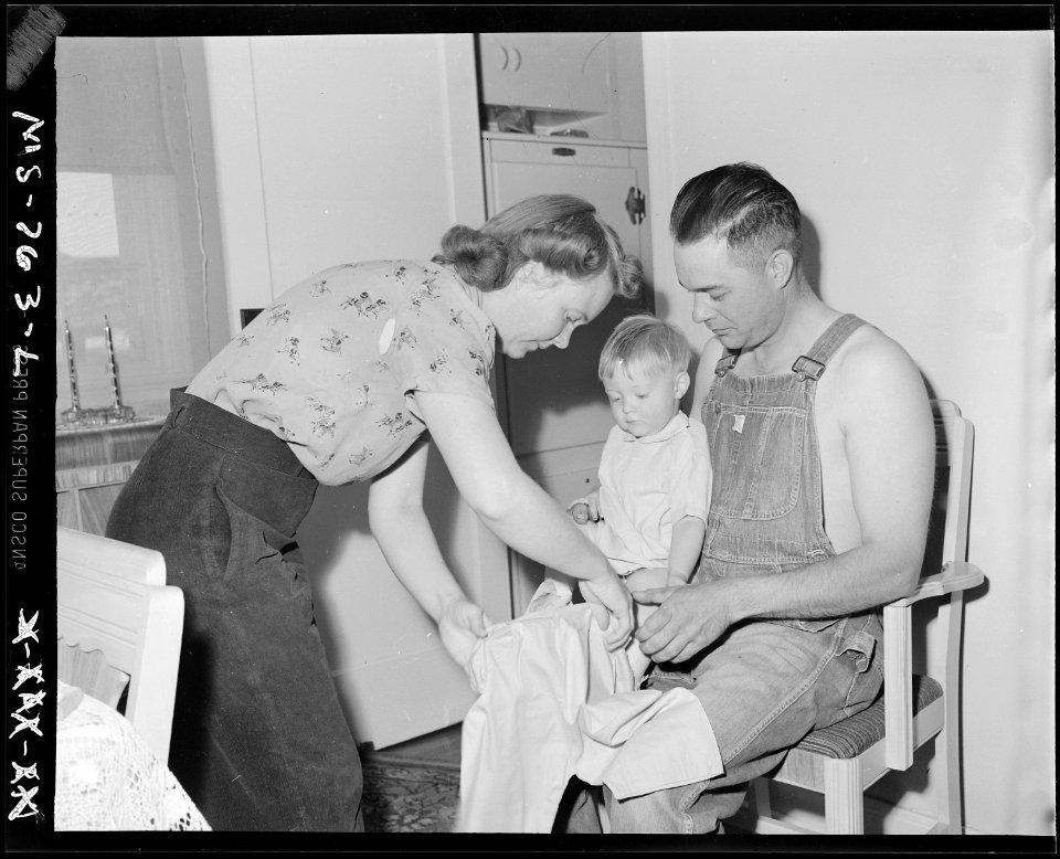 Mr. and Mrs. Thomas Overy change clothes on their baby. Union Pacific Coal Company, Stansbury Mine, Rock Springs... - NARA - 540587