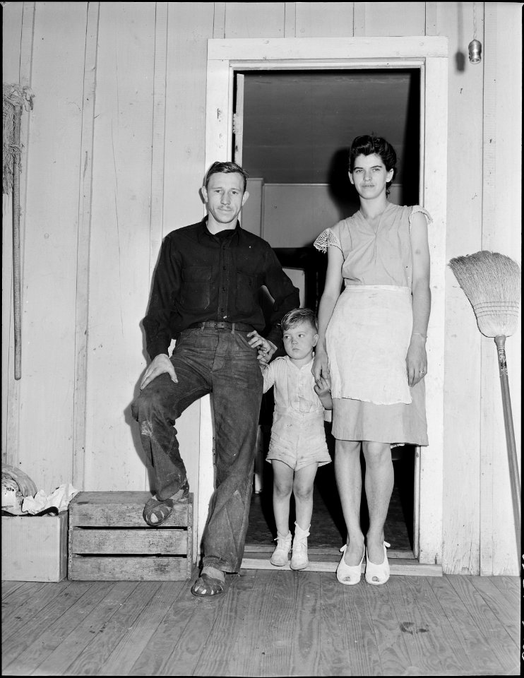 Mr. and Mrs. Tommy Swafford and their son in the doorway of their four room house, they pay $9 monthly rental plus... - NARA - 541011
