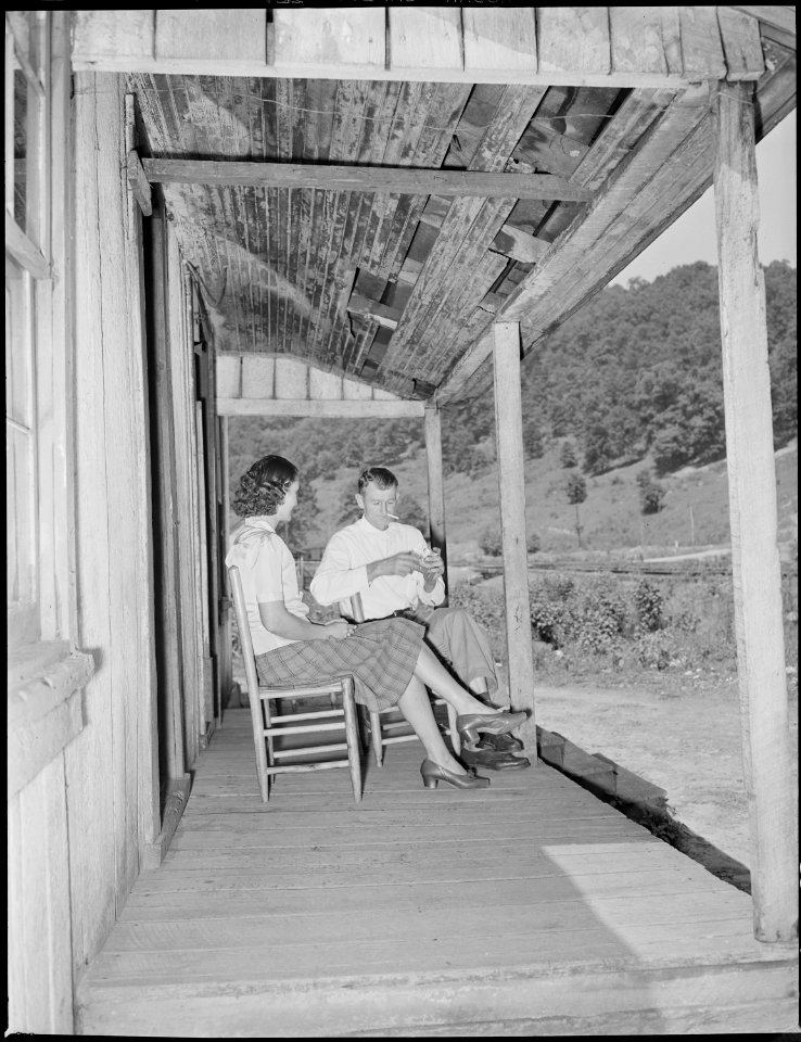 Mr. and Mrs. Oscar Powers on the front porch of the three room house for which they pay $4.50 monthly. In commenting... - NARA - 541167