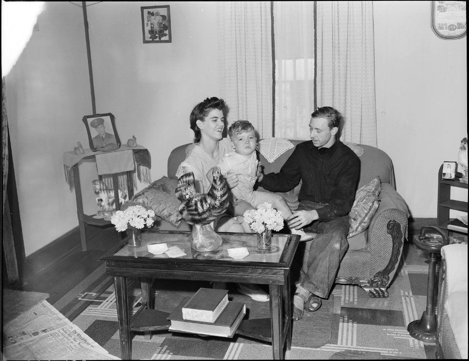 Mr. and Mrs. Tommy Swafford and their son in the living room of their four room house in which they have lived for... - NARA - 541014