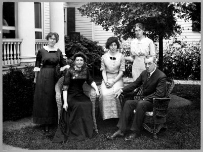 Mr. and Mrs. Woodrow Wilson seated outdoors with their three daughters standing behind them-(left to right) Margaret, Eleanor, and Jessie, in Cornish, New Hampshire LCCN2013649731