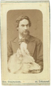 Mr. Znamenski, half-length portrait, facing left, holding stuffed head of a wolf in his lap LCCN99615517