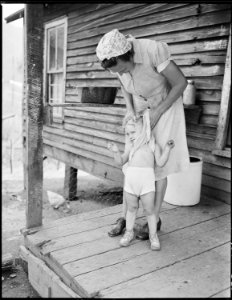 Mrs. Blaine Sergent washes her grandchild Freddy's face. P V & K Coal Company, Clover Gap Mine, Lejunior, Harlan... - NARA - 541325