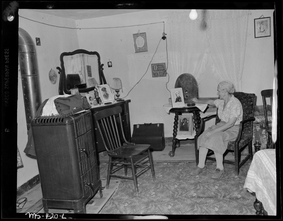 Mrs. Camillogasperetti, wife of old miner, in living room of their home in company housing project. Huerfano Coal... - NARA - 540403
