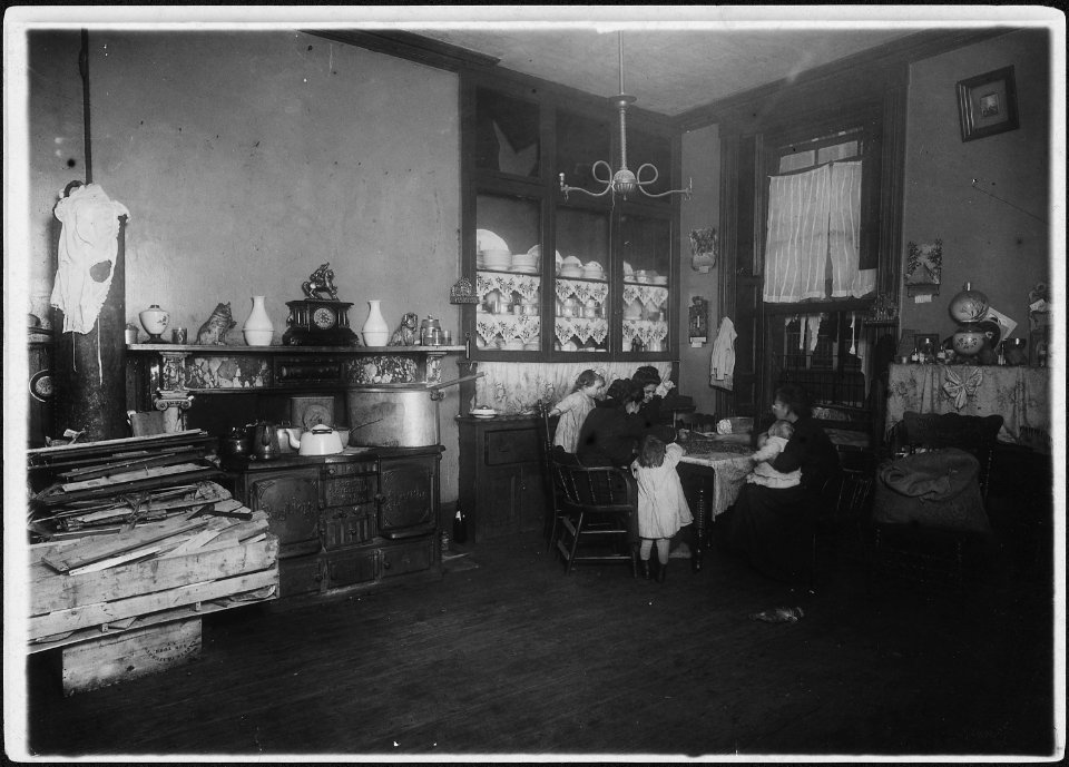 Mrs. Caporale, (a widow), picking nuts, while her two daughters help her. The dirty children are handling the nuts... - NARA - 523492
