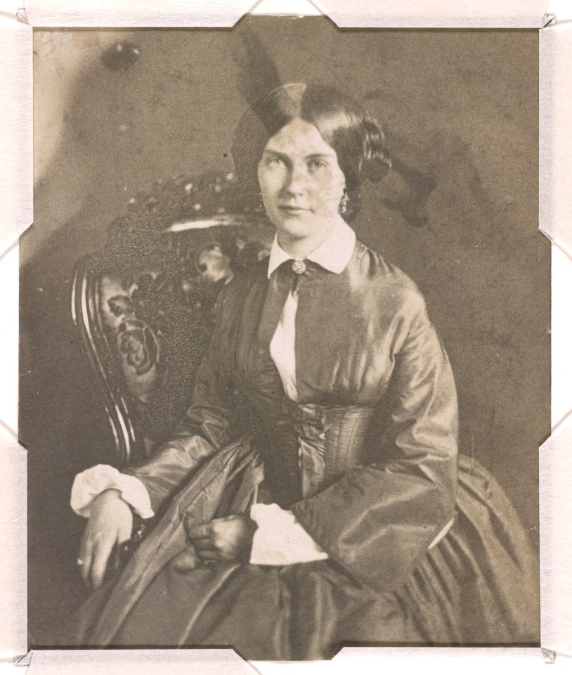 Mrs. Edwin Booth (Mary Devlin), three-quarter length studio portrait, seated with right hand resting on the arm of the chair and left hand on lap, facing front LCCN2015651560