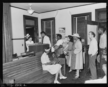 Mrs. Eva Ruth Gray, RN., receives patients at the clinic and gets out their case cards for the doctors. 2001 calls... - NARA - 540831
