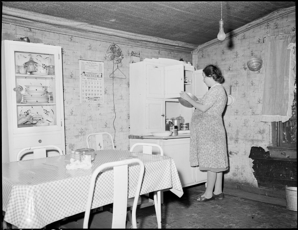 Mrs. Floyd Miller, wife of a miner, in the kitchen of their three room house for which they pay $6 monthly. They pay... - NARA - 541164