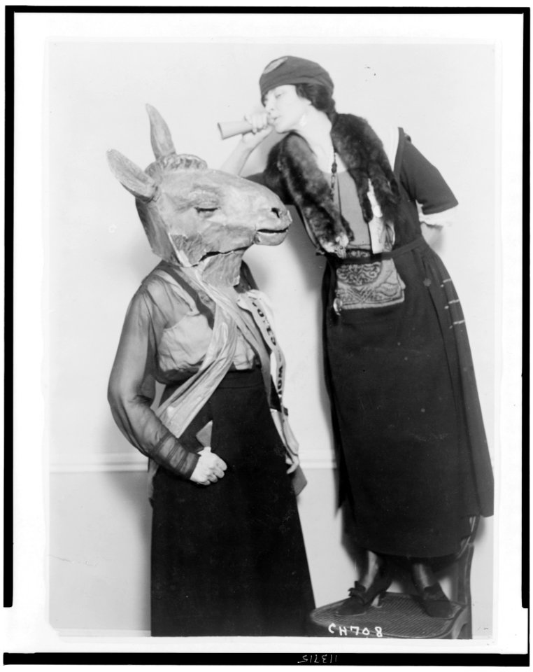 Mrs. Guilford Dudley of Nashville with ear trumpet, talking into ear of Democratic donkey, played by Mrs. Mary Semple Scott in skit at 1920 National American Woman Suffrage Association in LCCN95507721