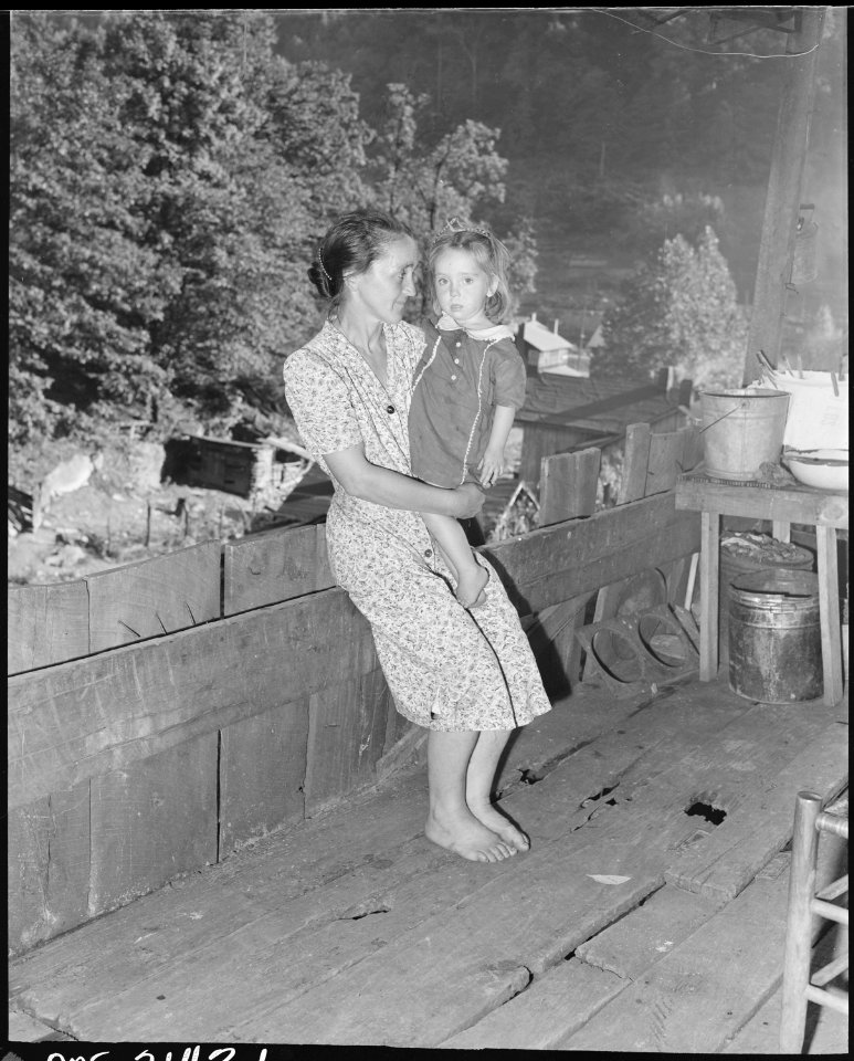 Mrs. Charlie Davis and her daughter on the front porch of their two room house. Coleman Fuel Company, Red Bird Mine... - NARA - 541135