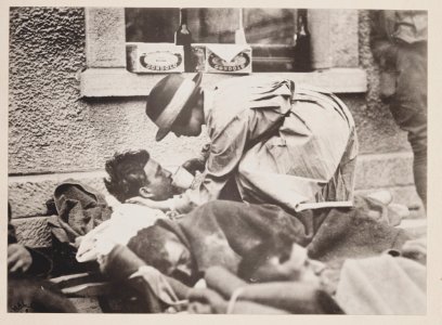 Mrs. Hammond, American Red Cross, serving water to badly wounded British soldiers on platform of railroad station at Montmirail, France LCCN2013645951