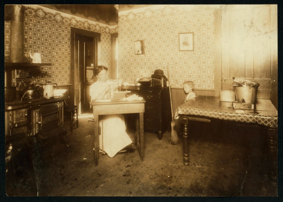 Mrs. Helems, Leeds, Mass., putting bristles into tooth brushes in an untidy kitchen. She makes about $4.65 a week usually. The sanitary conditions in most of these homes are pretty good, but LOC nclc.04260