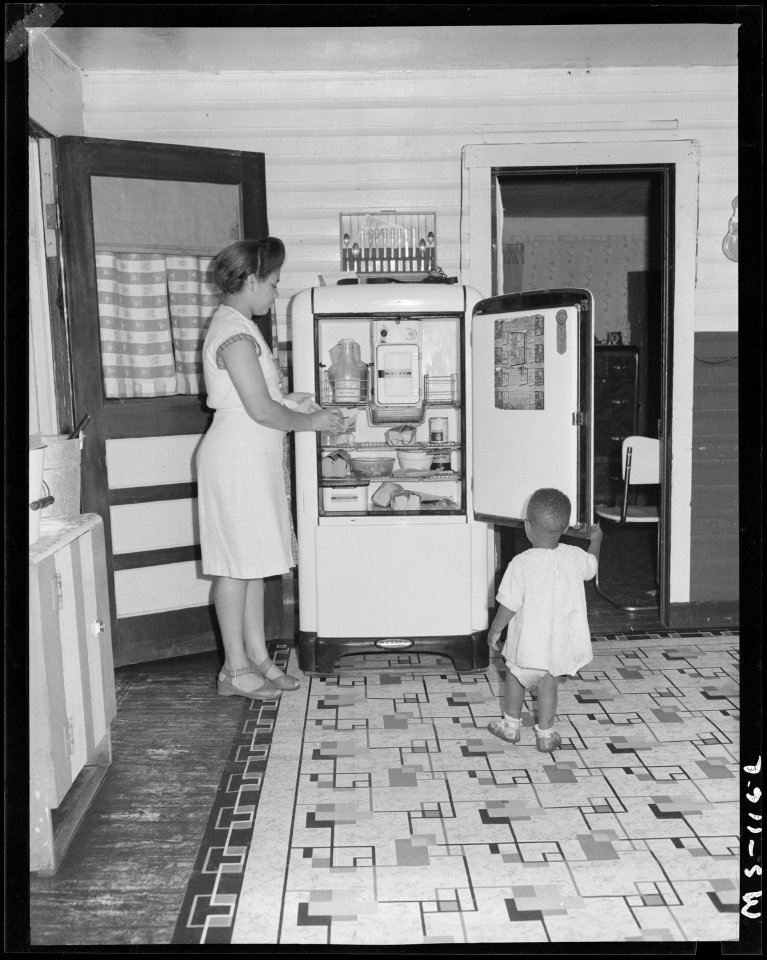 Mrs. Gonzalla Sullivan, wife of miner, in kitchen of her home in company housing project. Koppers Coal Division... - NARA - 540282