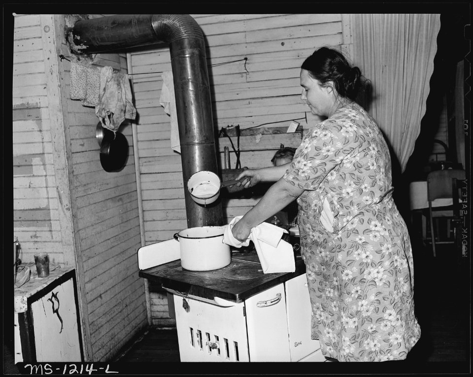 Mrs. J. F. Bryant, wife of miner, in her kitchen. The family lives in upstairs flat of two-family house. Water is... - NARA - 540733