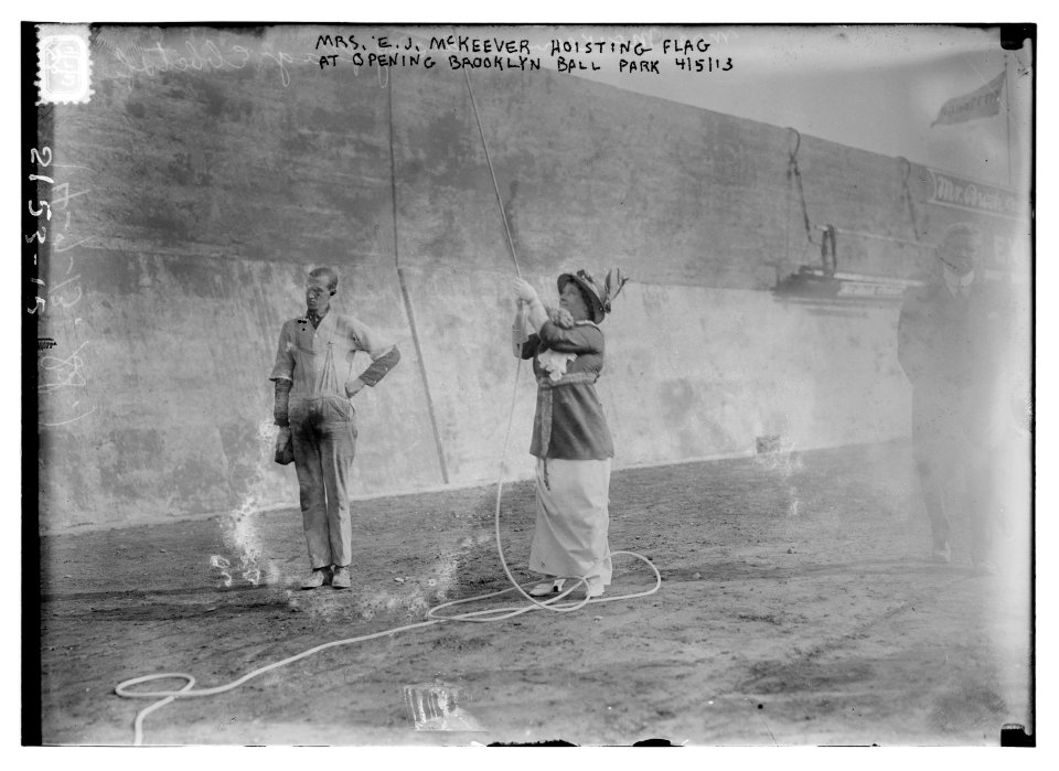 Mrs. E.J. McKeever hoisting flag at opening of Ebbets Field, Bklyn 4-5-13 built 1912 LCCN2014688997
