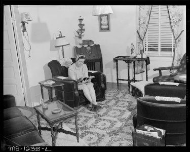 Mrs. Irene Shelton whose husband was killed in mine accident in July, 1946, in living room of her six room and bath... - NARA - 540747