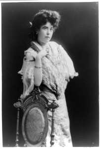Mrs. James J. Molly Brown, survivor of the Titanic, three-quarter length portrait, standing, facing right, right arm on back of chair LCCN92521036