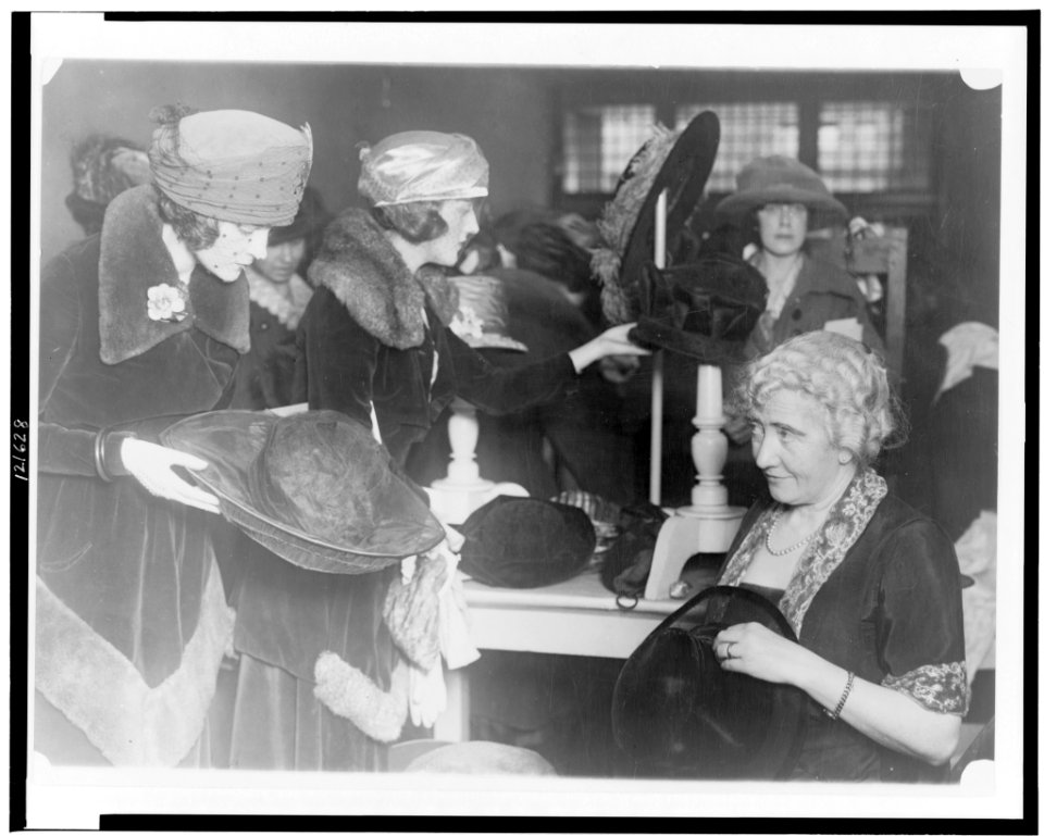 Mrs. Lawrence Townsend at the fourth annual rummage sale of the Child Welfare Society trims discarded hats for the price of one year's milk supply for a Washington baby LCCN98516418