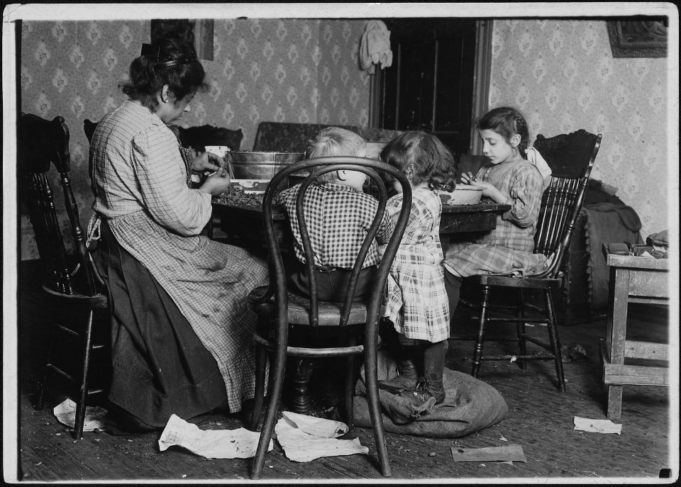Mrs. Lucy Libertime and family, Johnnie, 4 years old, Mary 6 years, Millie, 9, picking nuts in the basement tenement.... - NARA - 523489