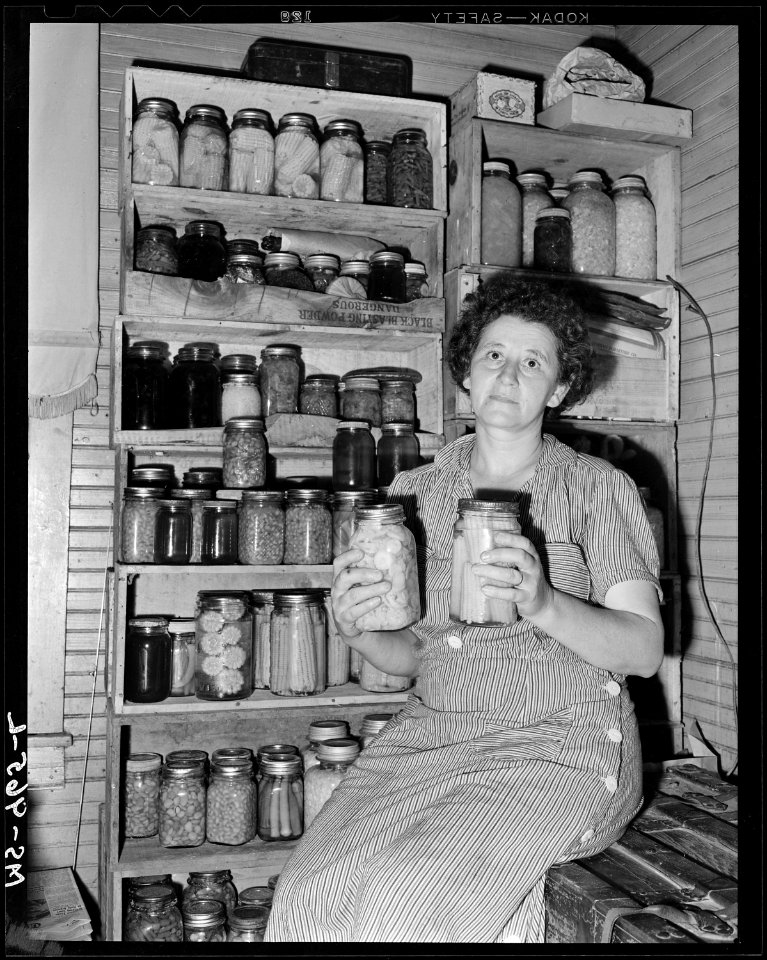 Mrs. Mack Brasseak, wife of miner, with some of the vegetables she has canned. Consolidated Coal Company, Bankhead... - NARA - 540634