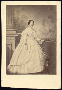 Mrs. Jefferson Davis, full-length studio portrait, standing, facing slightly right with left hand resting on the back of a chair LCCN2005677223