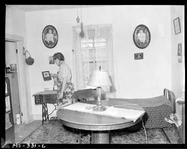 Mrs. Molly Genoff, wife of miner in living room of her home. Puritan Camp, Erie, Colorado. - NARA - 540360 photo