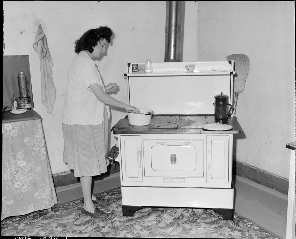 Mrs. Paul May, wife of miner, in the kitchen of her four room house. She has no running water in the house. Jewell... - NARA - 540978