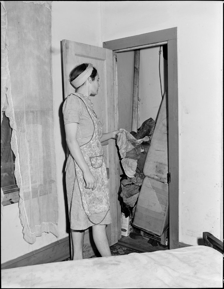 Mrs. Phillip Asbury, wife of miner, at the one closet in her four bedroom house. Panther Red Ash Coal Corporation... - NARA - 541012