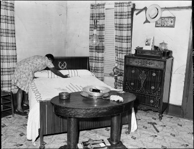 Mrs. Robert Harold in downstairs bedroom of her home. She and her husband have lived in this house for sixteen years.... - NARA - 541056 photo