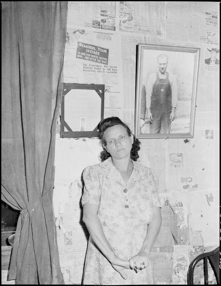 Mrs. Leanore Miller, widow of a miner, with a picture of her husband. She said, there's more widows and orphens in... - NARA - 541245