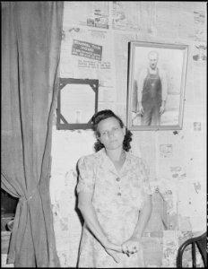Mrs. Leanore Miller, widow of a miner, with a picture of her husband. She said, there's more widows and orphens in... - NARA - 541245