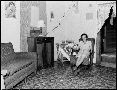Mrs. Sergent in her living room. She is an immaculate housekeeper, she is forty-six years old and has given birth to... - NARA - 541362