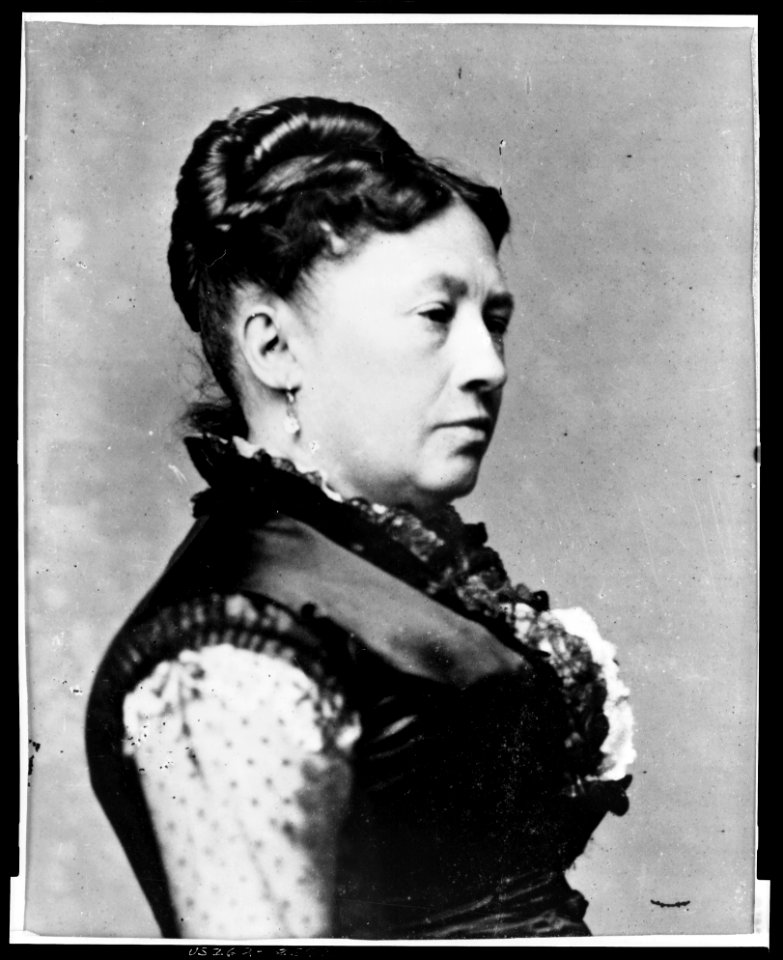 Mrs. Ulysses S. Grant, full-length portrait, standing, facing right, between table and chair LCCN96525595