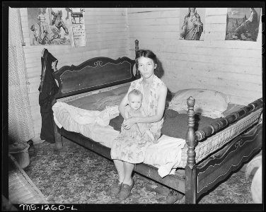 Mrs. Walter Rose, wife of miner, and her baby. She lives in three room, extremely dirty house. The baby probably has... - NARA - 540759 photo