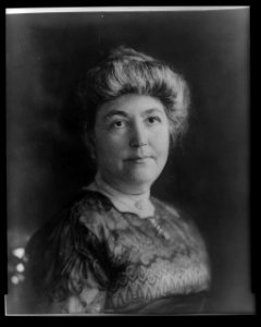 Mrs. Woodrow Wilson (Ellen Axson), full-length portrait, seated, facing right, holding flowers LCCN96525397