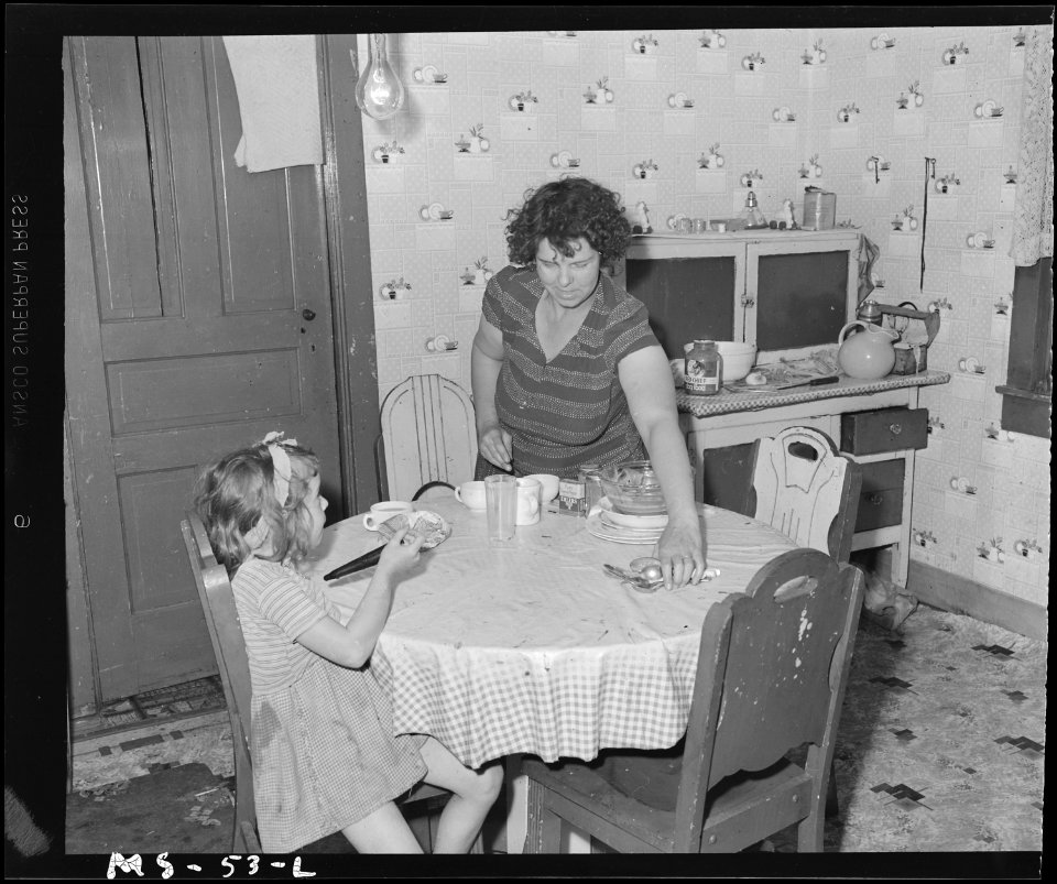 Mrs. William Simpson, wife of miner, cleaning table in kitchen of house ^43 of company housing project. Louise Coal... - NARA - 540245