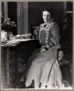 Mrs. Theodore Roosevelt, three-quarters length portrait, seated at desk, facing forward LCCN96525604 photo
