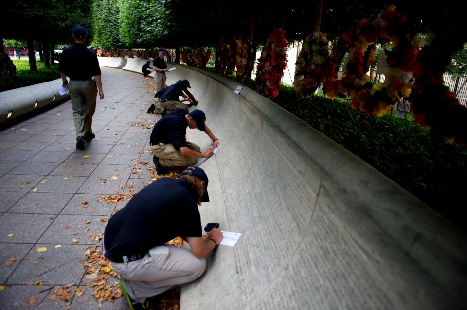 Multiple law enforcement explorers tracing on the National Law Enforcement Officers Memorial