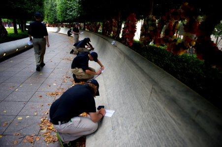 Multiple law enforcement explorers tracing on the National Law Enforcement Officers Memorial