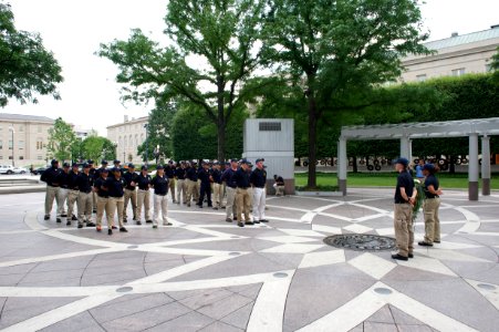 Multiple law enforcement explorers stand at attention at the National Law Enforcement Officers Memorial photo