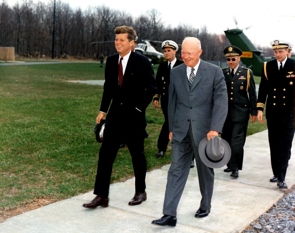 Meeting with President Eisenhower. President Kennedy, President Eisenhower, military aides. Camp David, MD. - NARA - 194198