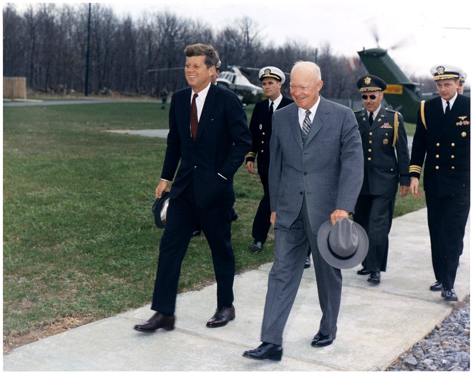Meeting with President Eisenhower. President Kennedy, President Eisenhower, military aides. Camp David, MD. - NARA - 194198