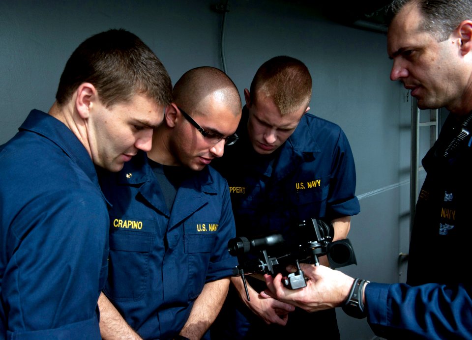 US Navy 110528-N-DR144-901 Master Chief Quartermaster Jonathan Myers teaches midshipmen how to use a sextant for celestial navigation