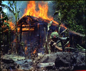 My Tho, Vietnam. A Viet Cong base camp being. In the foreground is Private First Class Raymond Rumpa, St Paul, Minnesota - NARA - 530621 photo