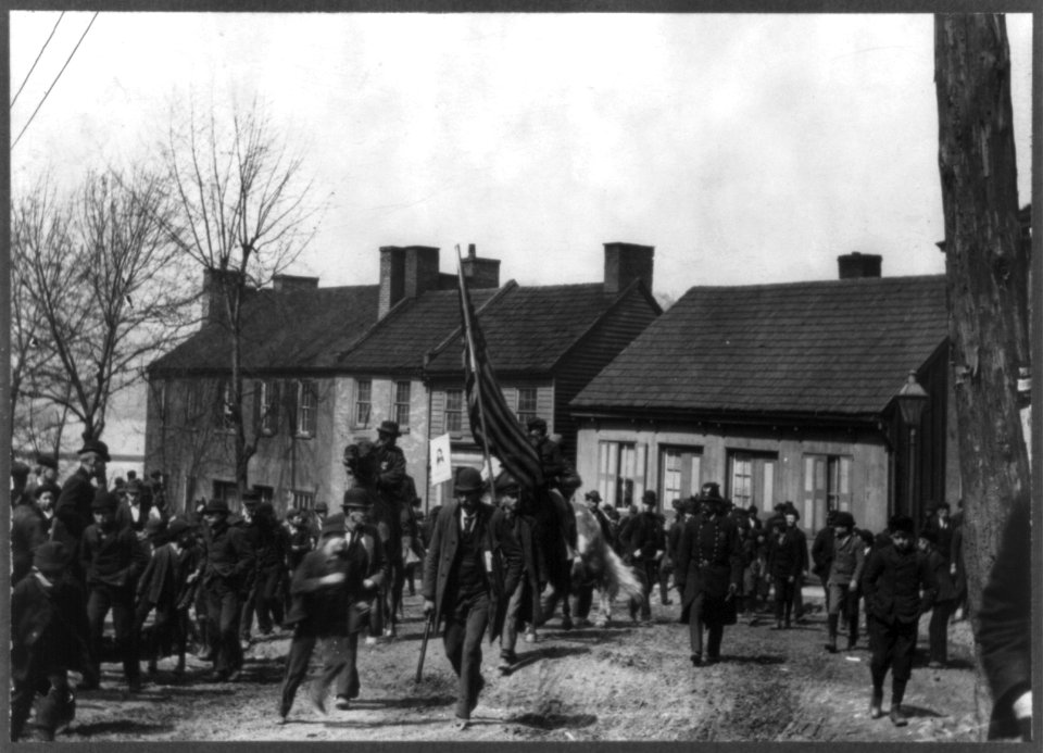 Members of Coxey's Army- men and boys, with flag bearer in center LCCN2006681175